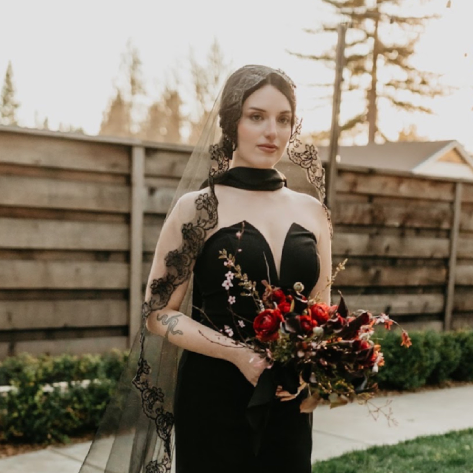 Bridal bouquet featuring deep crimson ranunculus, chocolate cosmos, burgundy lilies and blooming branches. Florals by Golden Flowers for a gothic romance styled shoot at The National Exchange Hotel , Nevada City. Photo: Alyssa Keys Photography . Planner: Relic Events . Hair and Makeup: Courtney Sage